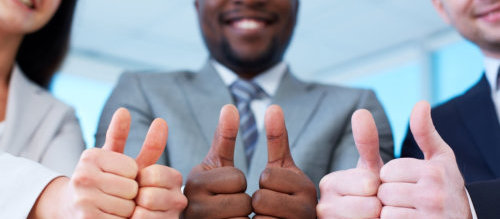 three business partners keeping thumbs up