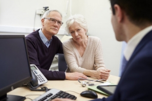 elderly couple meeting with consultant